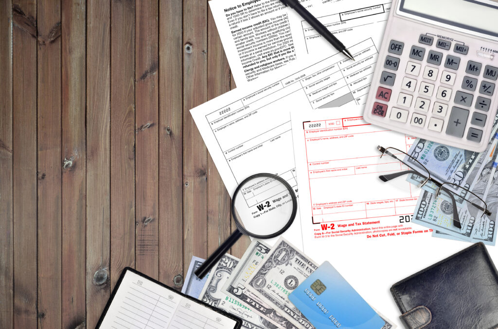 Taxpayer organizing W-2, 1099, dependent, business, rental, and deduction documents before filing taxes.