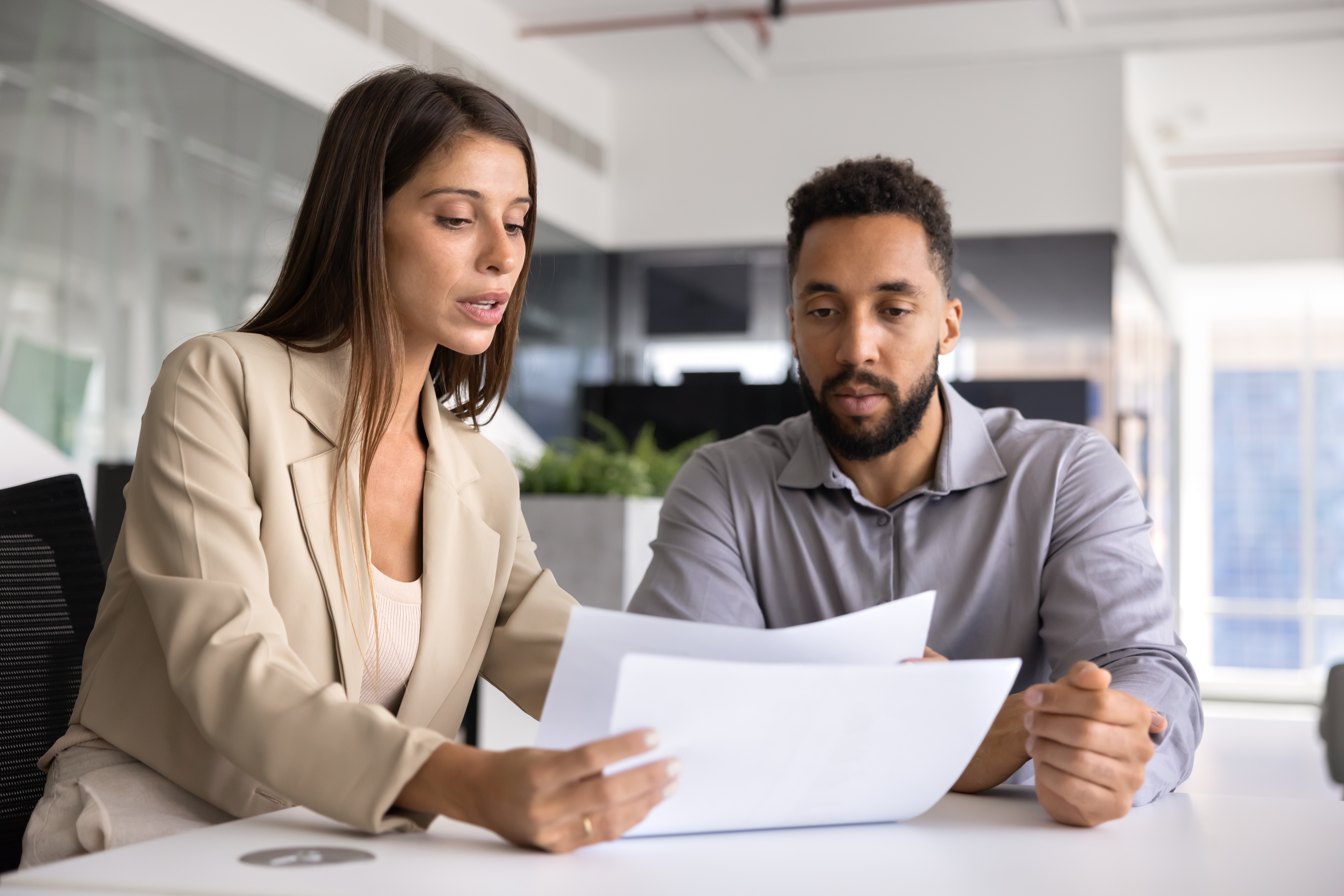 Self-employed taxpayer calculating quarterly estimated tax payments to the IRS with a tax professional.