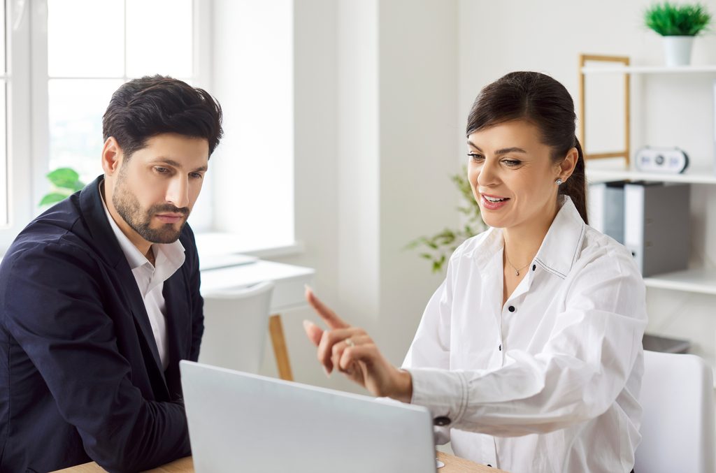 Taxpayer reviewing an IRS Offer in Compromise and tax debt settlement options with a professional tax planner.